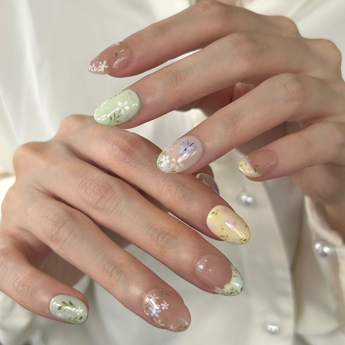 Close-up of hands with floral GELLY press-on nail design