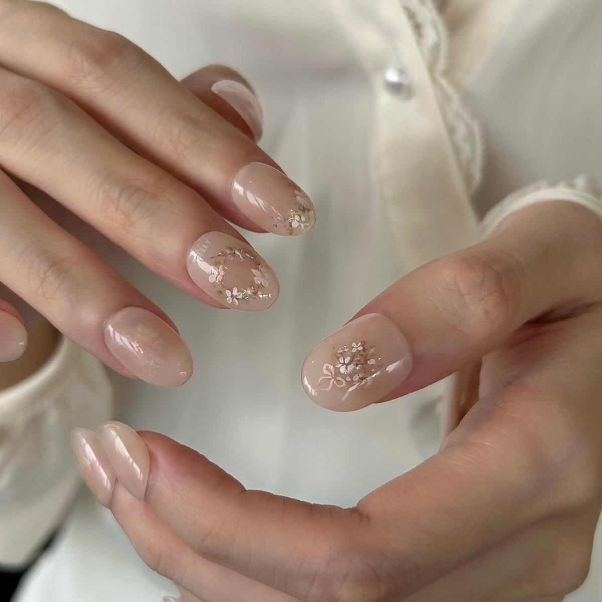Close-up of hands with floral GELLY press on nails