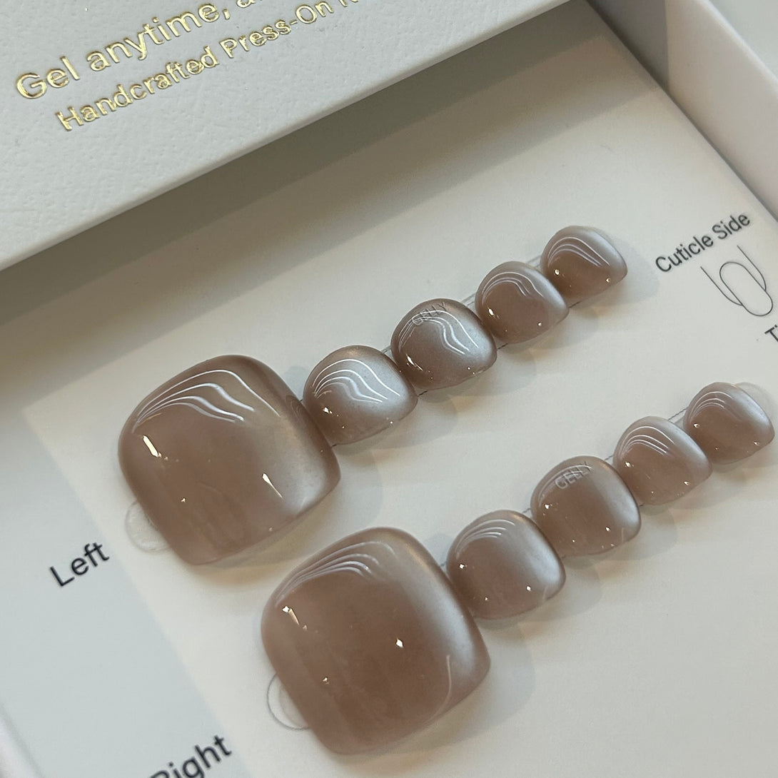 Set of press-on nails with a brown color on a white background