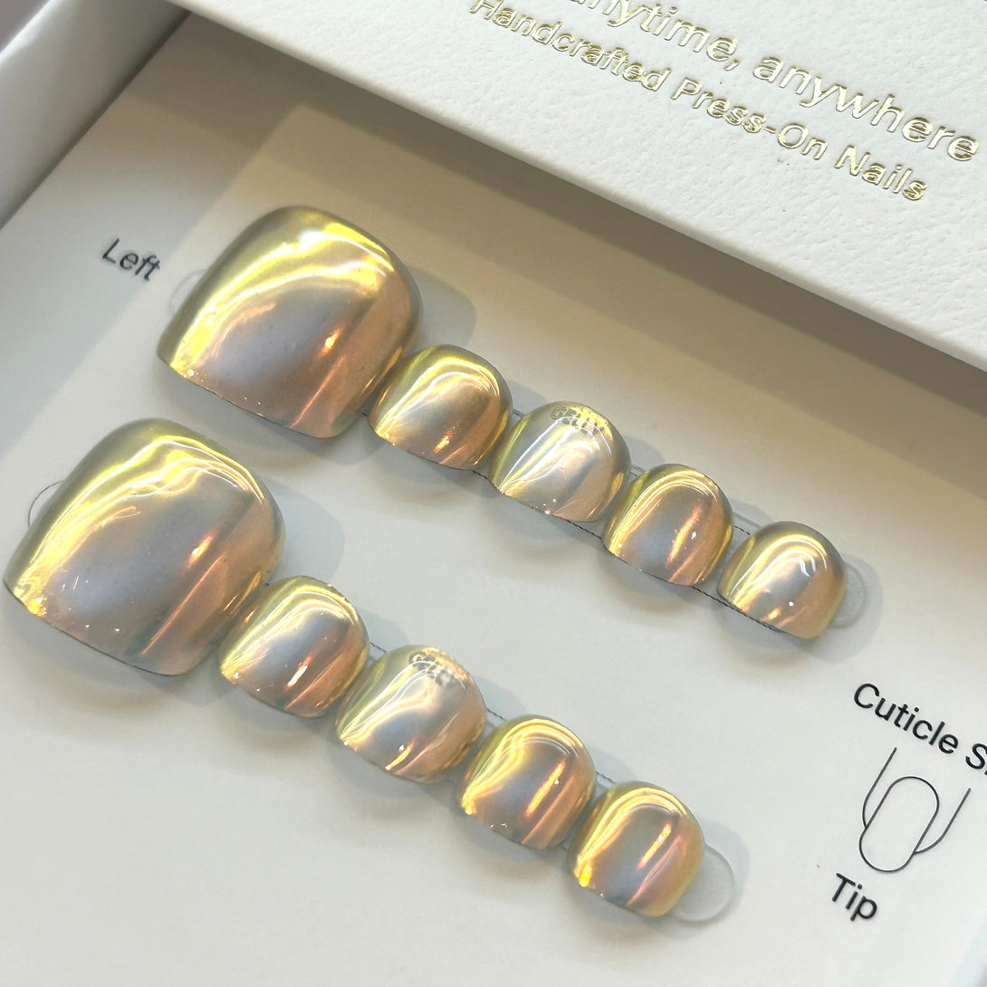 Set of gold and silver press-on nails in a clear plastic case.
