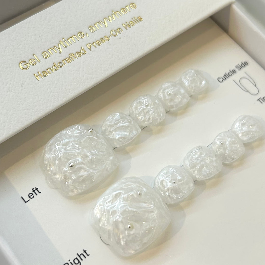 Set of press-on nails in a box with text 'Gel anytime, anywhere' and 'Handcrafted Press-On Nails'.
