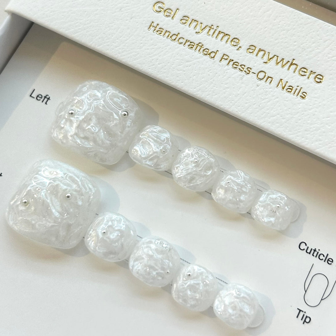 Set of press-on nails in a box with text 'Gel anytime, anywhere Handcrafted Press-On Nails'.