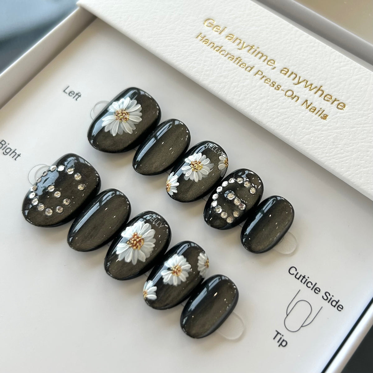 Set of press-on nails with floral designs in a box labeled 'Girl anytime, anywhere'.