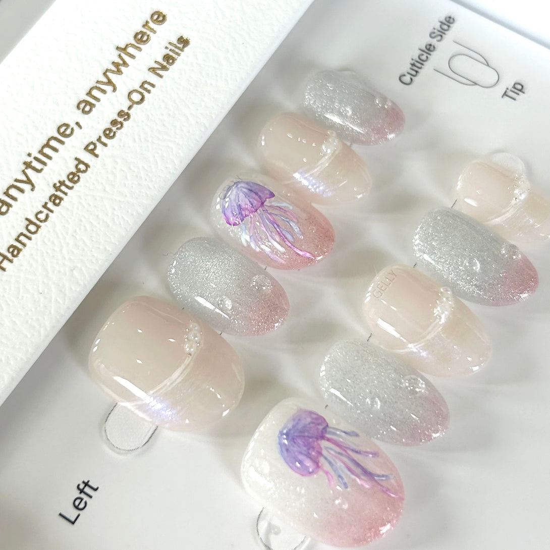 Set of press-on nails with jellyfish design in a box labeled 'Anytime, anywhere handcrafted Press-On Nails'.