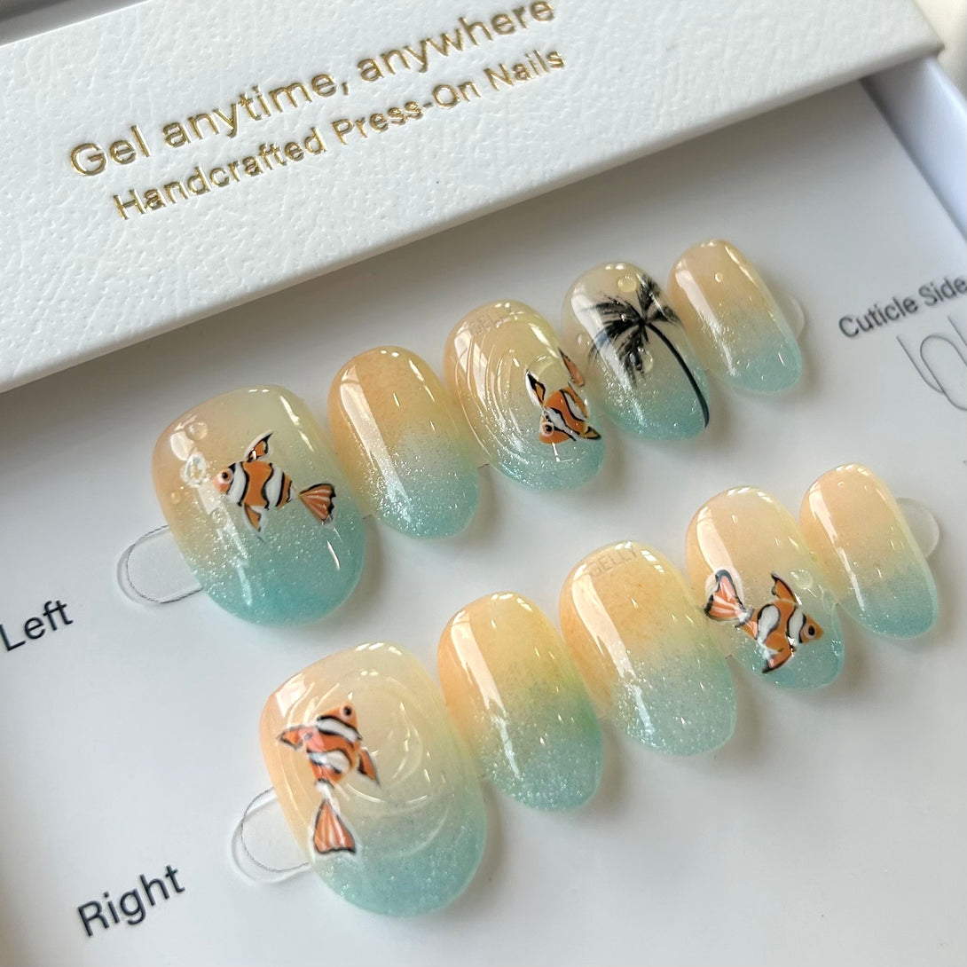 Set of press-on nails with fish design on a white background