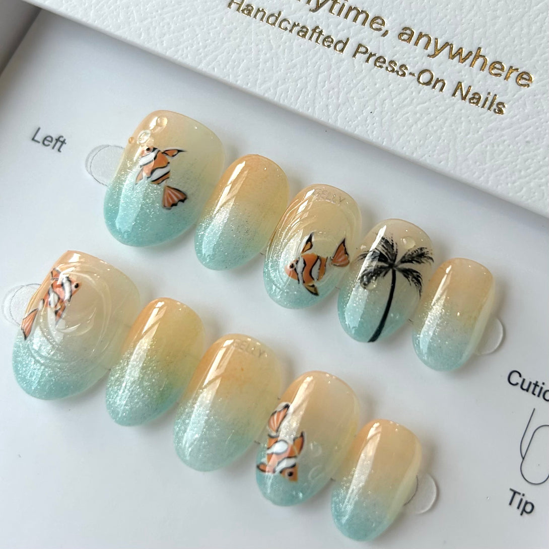 Set of press-on nails with tropical designs on a white tray.