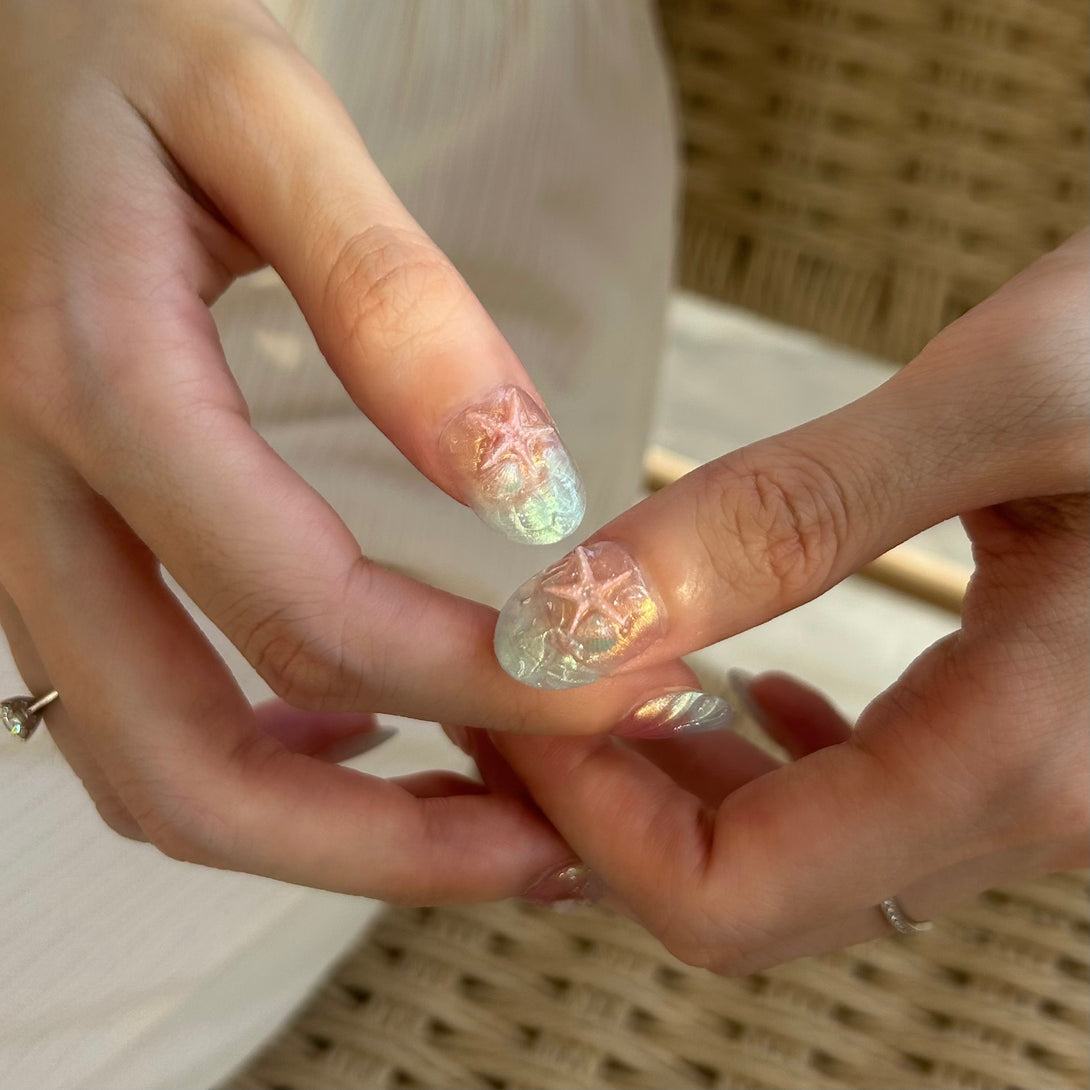 Close-up of hands with glittery nail polish on a blurred background