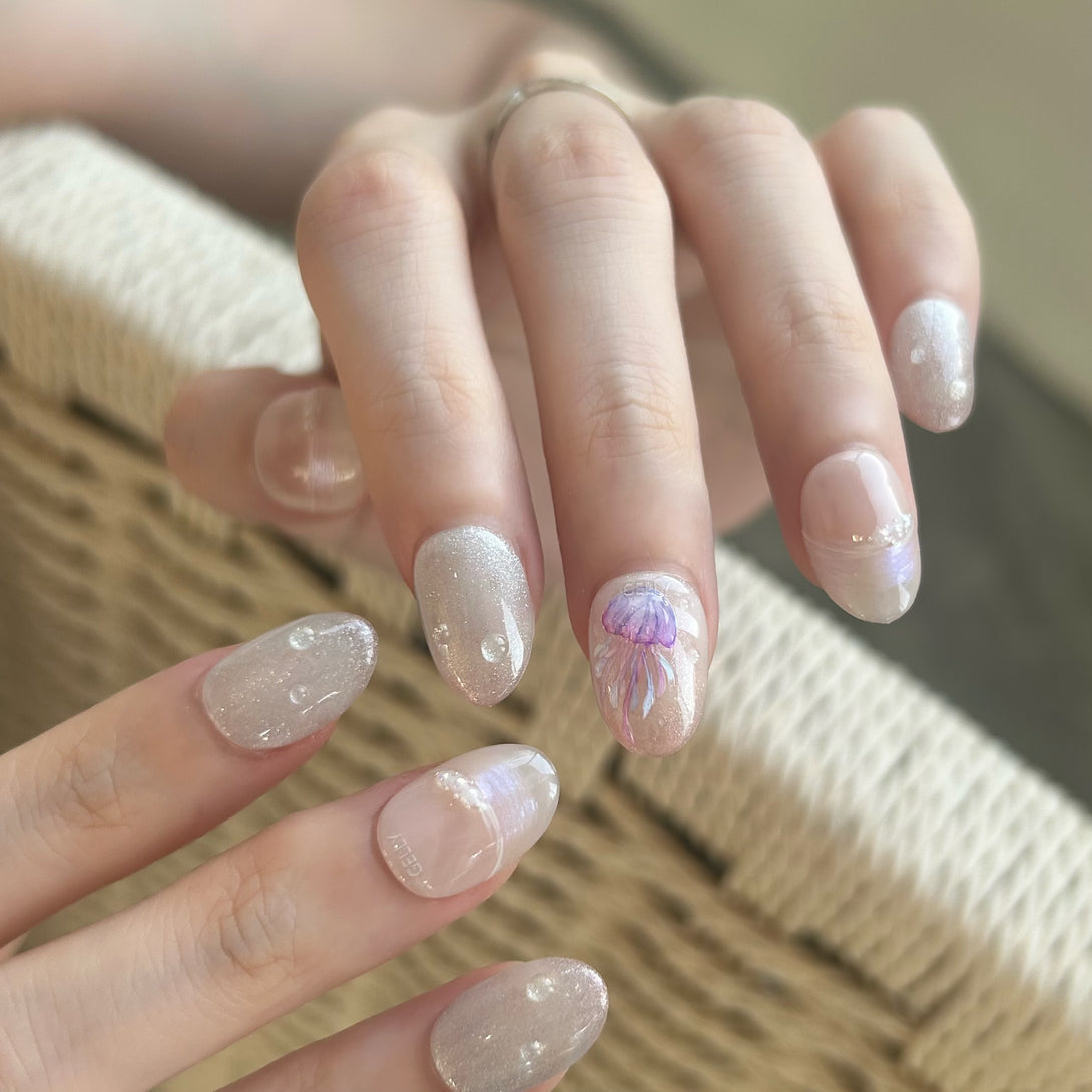 Close-up of a hand with decorative nail art on a textured surface