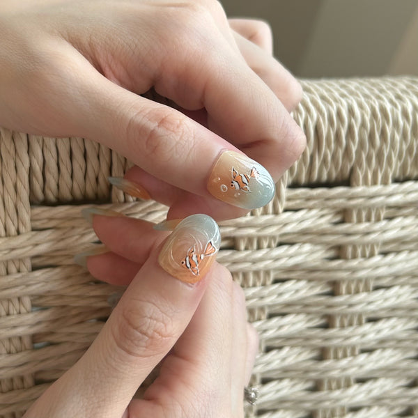 Close-up of hands with decorative nail art against a woven background
