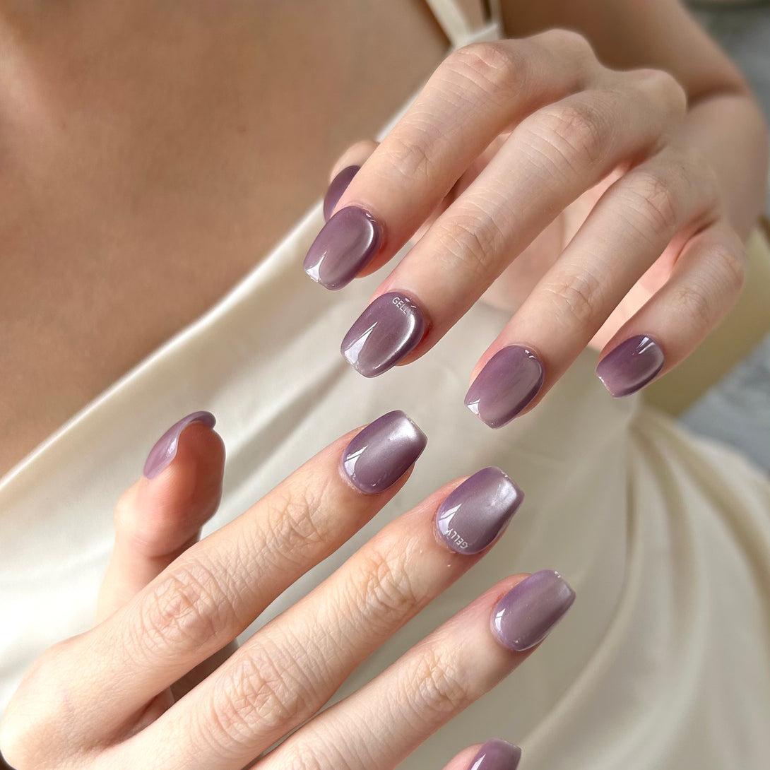 A girl is wearing purple cat eye press on nail 女生貼了紫色貓眼穿戴甲